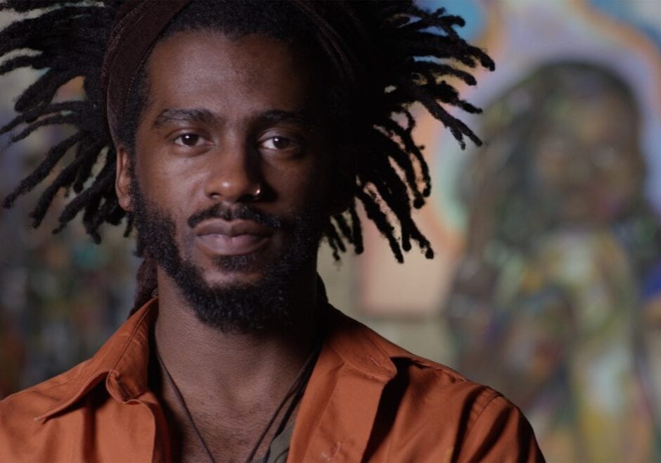 A man standing in front of a mural