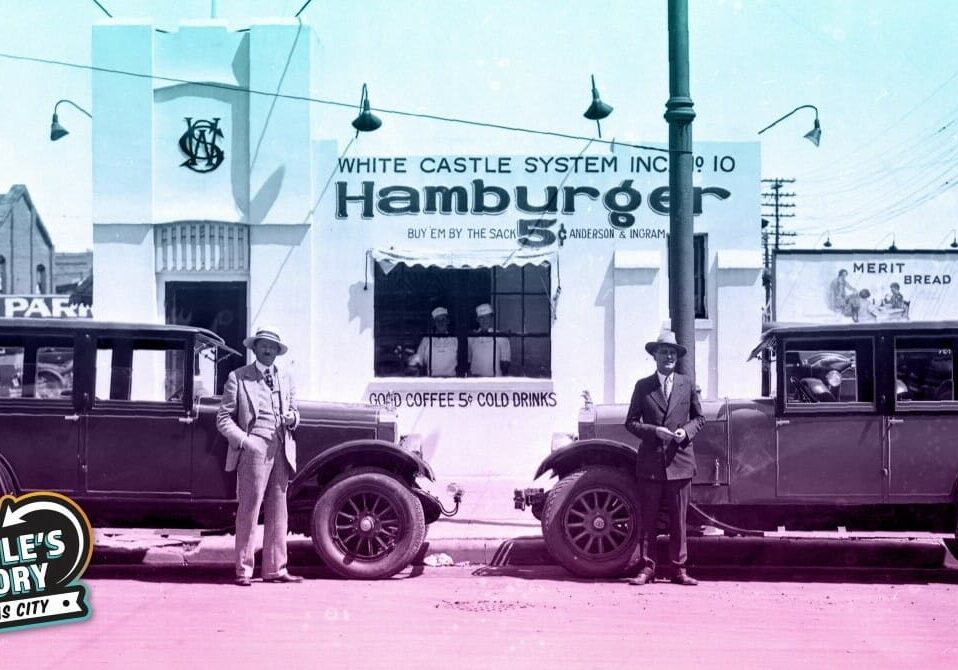White Castle founders Walt Anderson and Billy Ingram stand next to two automobiles outside of White Castle number 10, located at 318 West Douglas Avenue in Wichita, Kansas. The sign on the building reads: "White Castle System, Inc. No. 10 - Hamburger - Buy 'em by the sack 5¢ Anderson and Ingram." Two employees can be seen posing in the window, which advertises "Good coffee 5¢ Cold drinks."