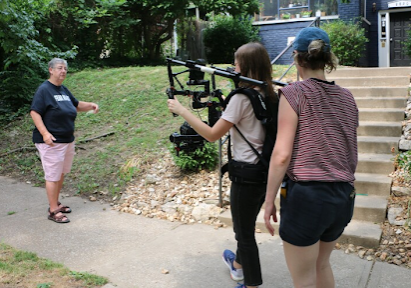 The Womontown documentary features co-founders Andrea Nedelsky and Mary Ann Hopper walking through their old neighborhood in Midtown Kansas City. Emily Woodring and Brydie O'Connor of Kansas City PBS film Nedelsky discussing Womontown's history.