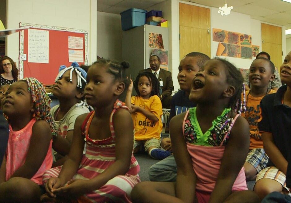 Students at the YMCA Summer Learning Loss Prevention program at Satchel Paige Elementary listen to a story last summer. The YMCA is one of several community partners working with KCPS to expand summer learning outreach. (Photo by Lindsey Foat) 