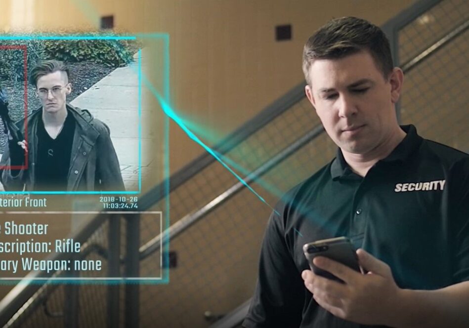 A security guard monitors a video feed.