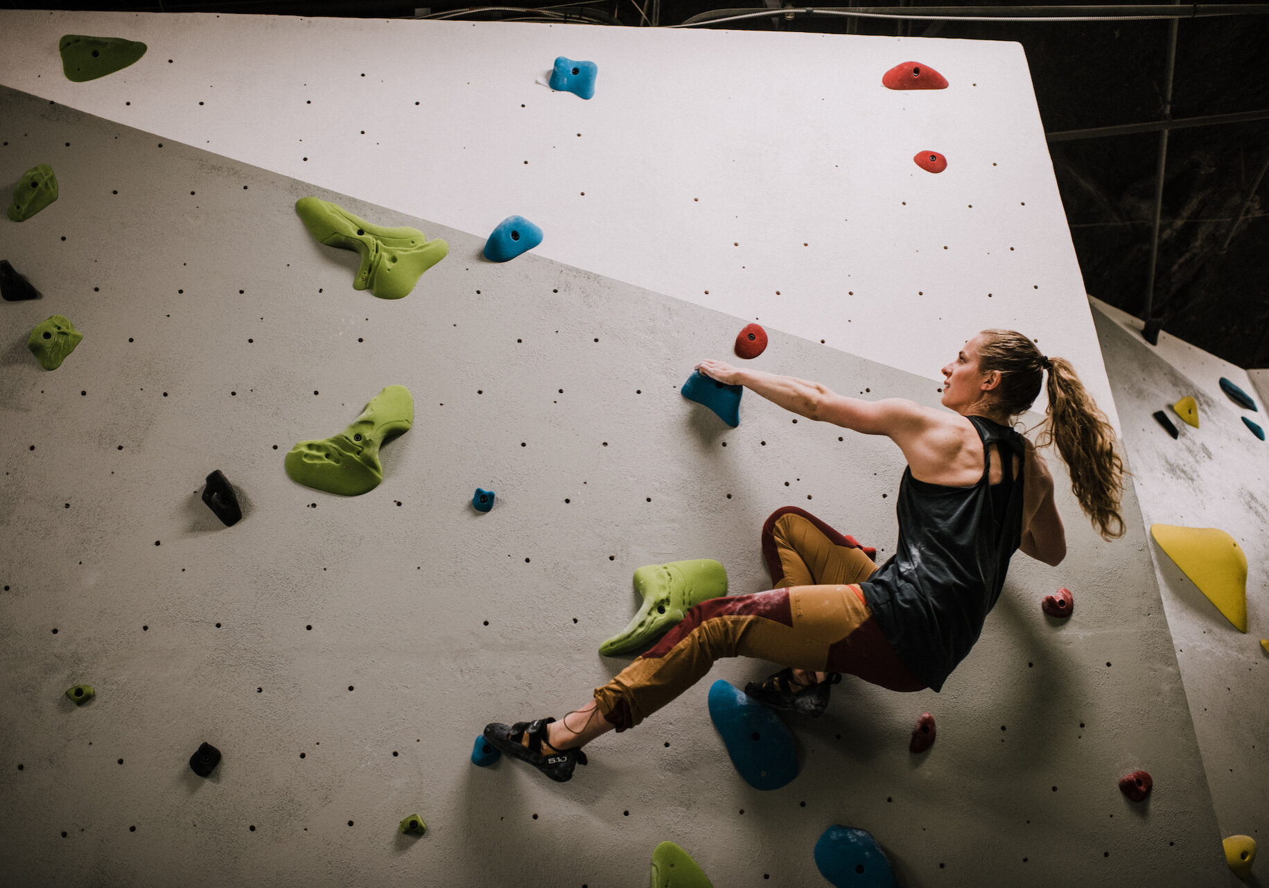A climber reaches for the next hold.