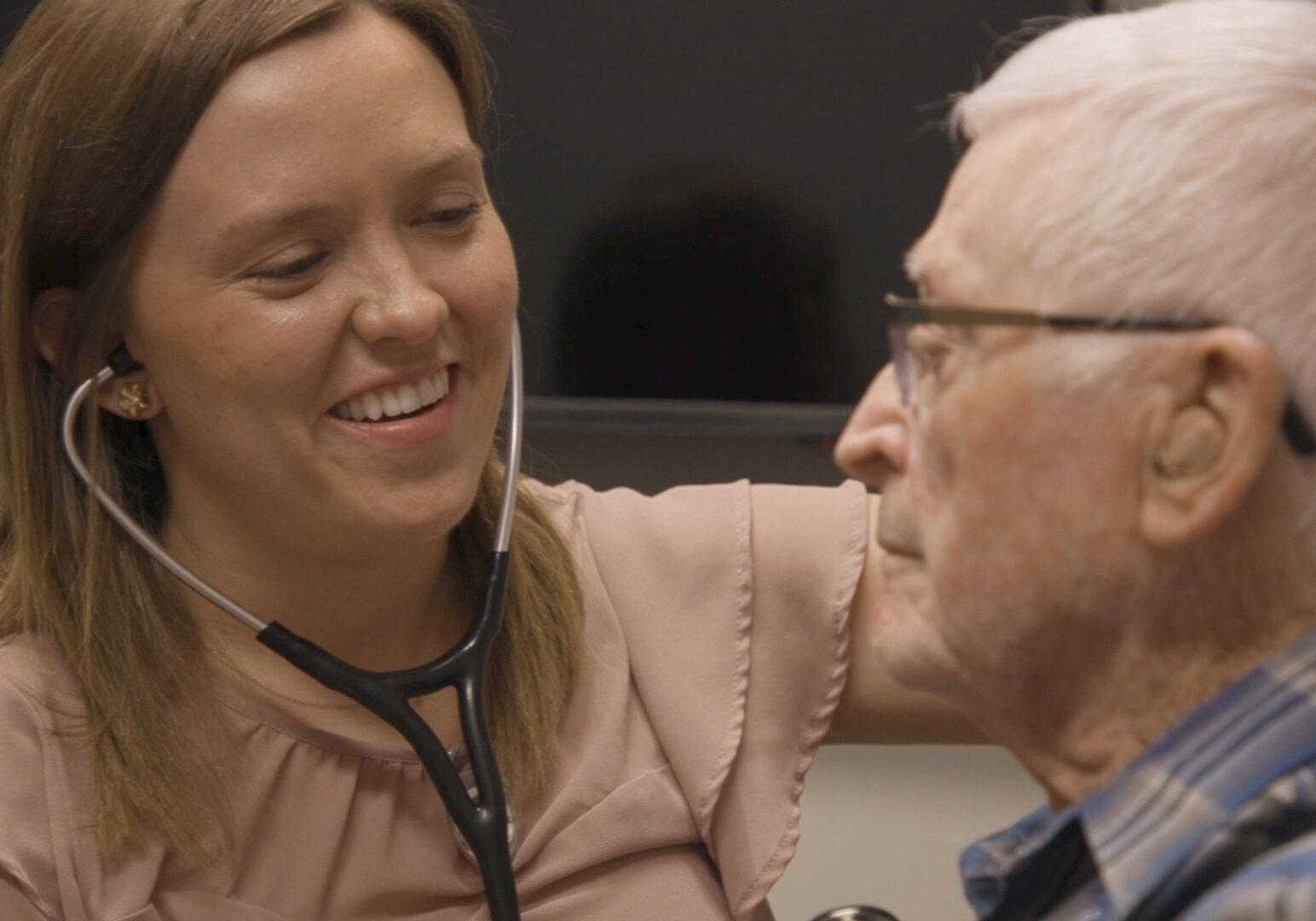 A medical student examines a patient