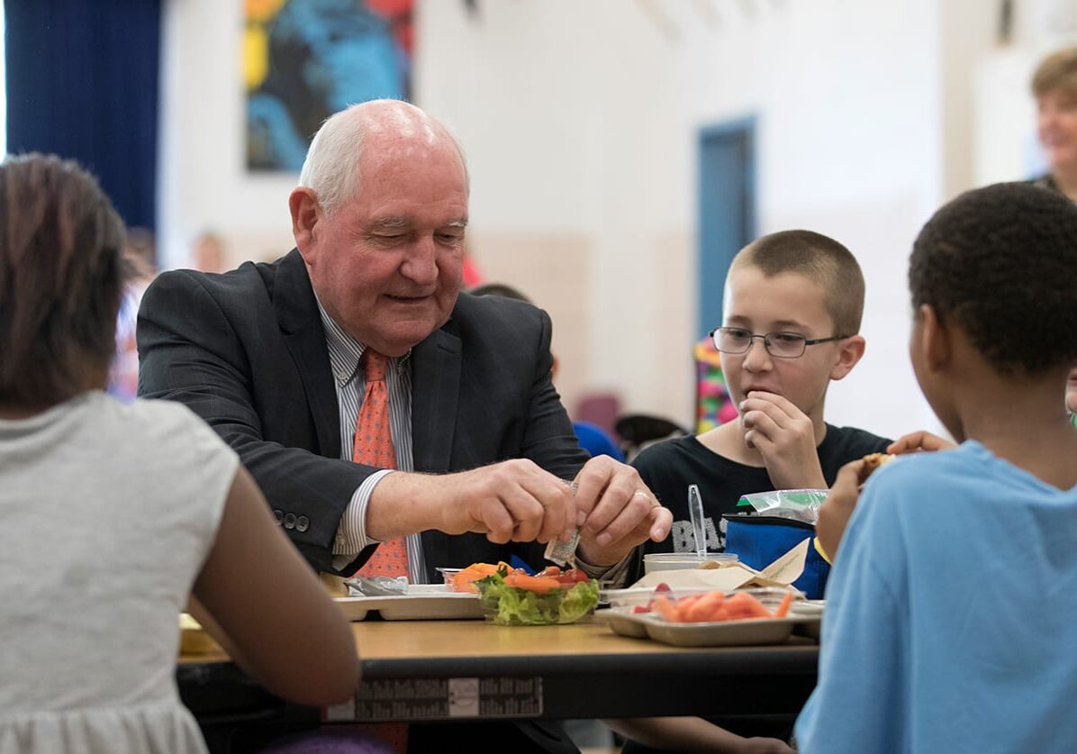 Agriculture Secretary Sonny Perdue eats lunch with students at the Catoctin Elementary School in Leesburg, Va., on Monday.