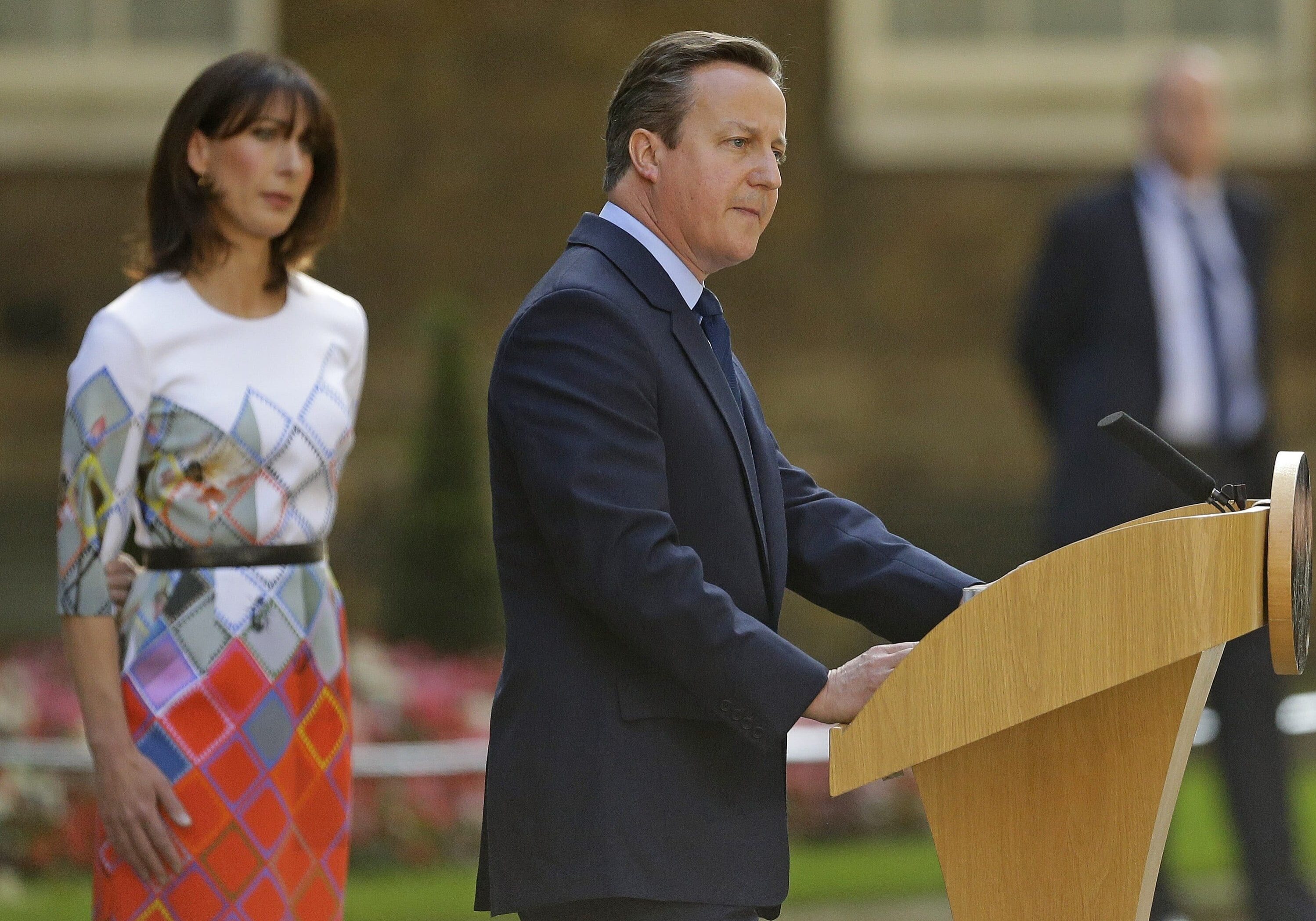 Britain's Prime Minister David Cameron speaks outside 10 Downing Street, London, as his wife Samantha looks on. Cameron says he will resign by the time of the Conservative Party conference in the fall.