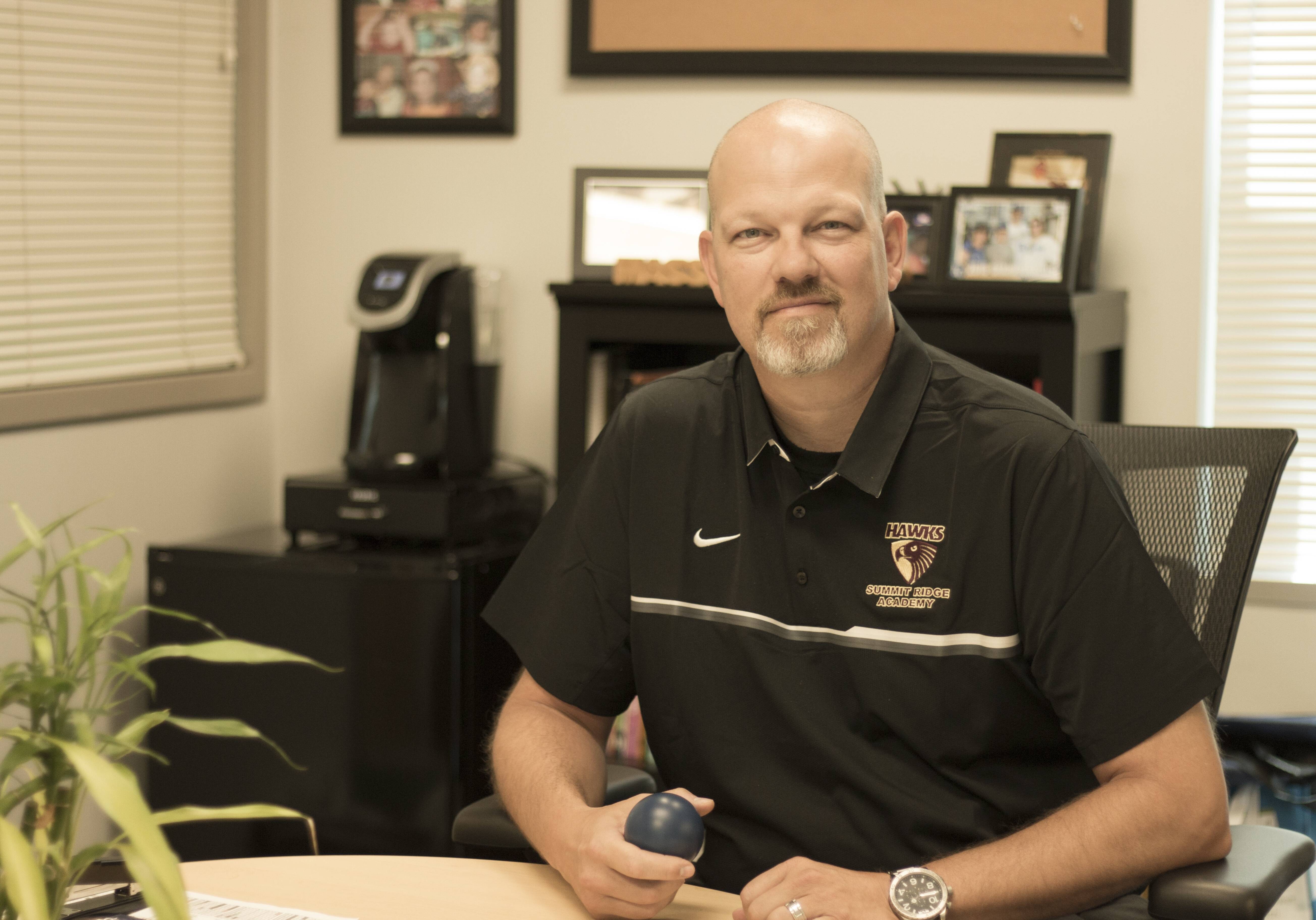 Andy Campbell, principal at Summit Ridge Academy in Lee's Summit, Missouri, holds one of the "fidgets" staff uses to help calm students as part of the building's trauma-informed care approach. (Brad Austin | Flatland)
