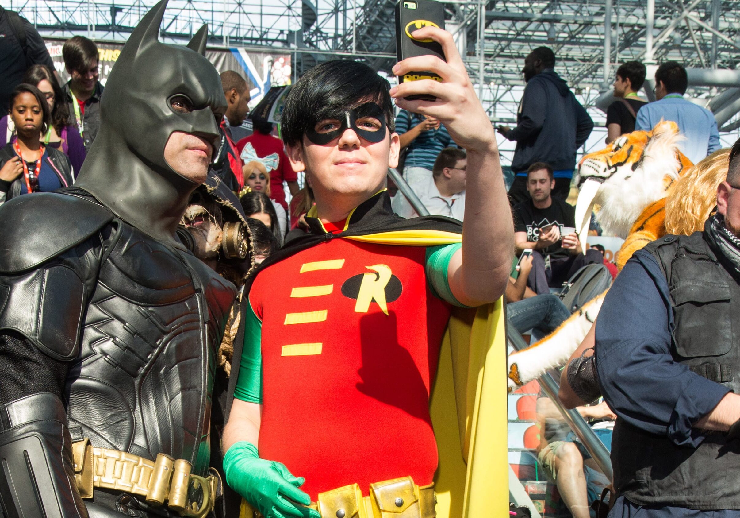 Two grown men dressed as batman and robin