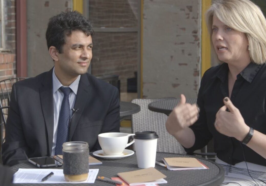 Allyson Hile, director of language sercies in the Kansas City Public School District, and Aditya Voleti, director of community and partnership at The Lean Lab, discuss immigration and education over coffee at Thou Mayest. (Kevin Allen | KCPT)