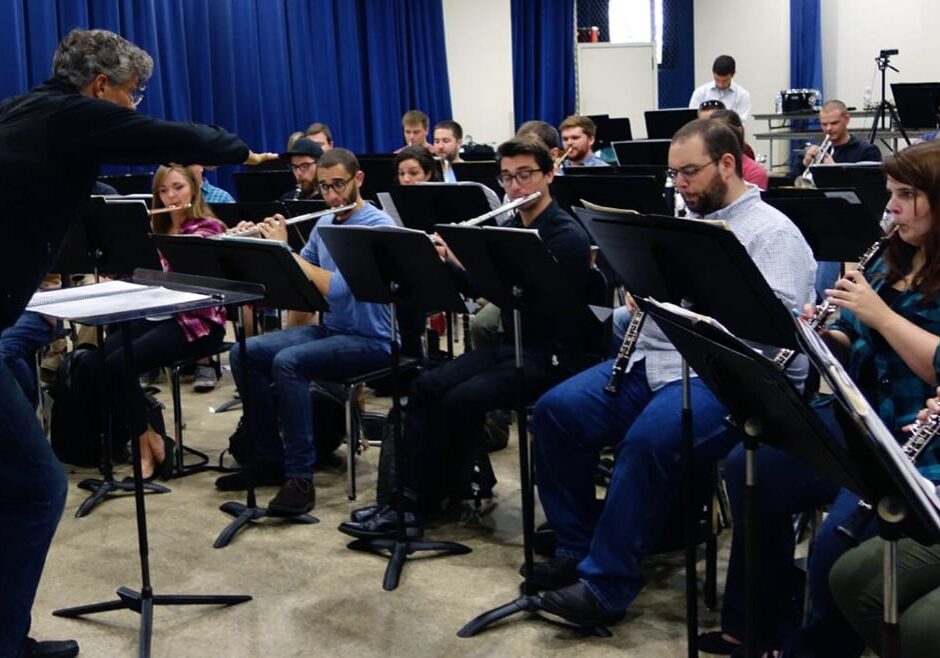 A conductor and student wind ensemble