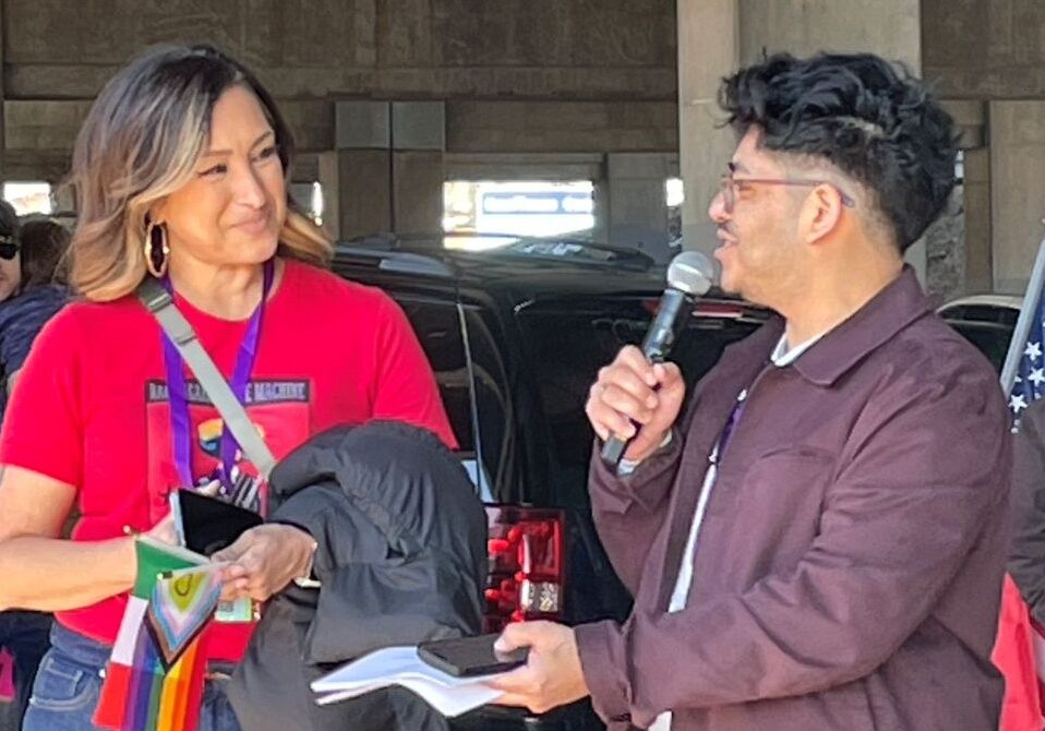 Deanna Munoz and Ivan Ramirez speak at a rally in support of the immigrant and LGBTQ communities on Feb. 23 in Kansas City. CoreCivic, a publicly traded operator of private prisons, wants to open a facility in Leavenworth, Kansas, to assist President Donald Trump's mass deportation plan. (Mary Sanchez/The Beacon)