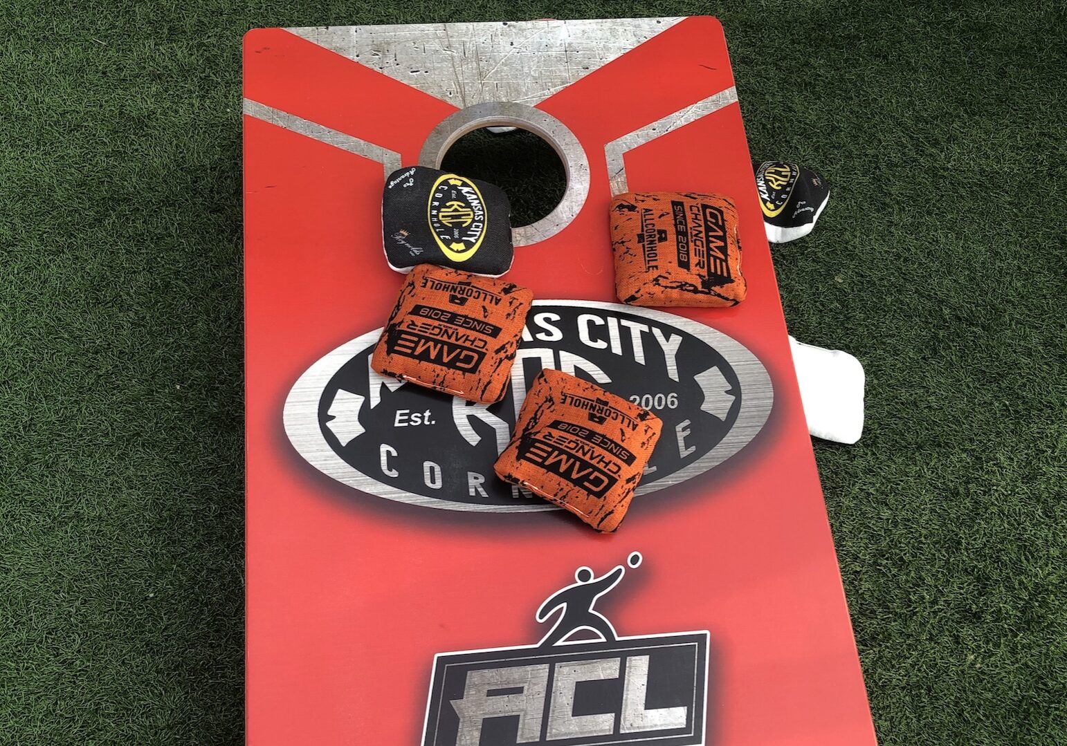 A cornhole board is covered with bean bags.