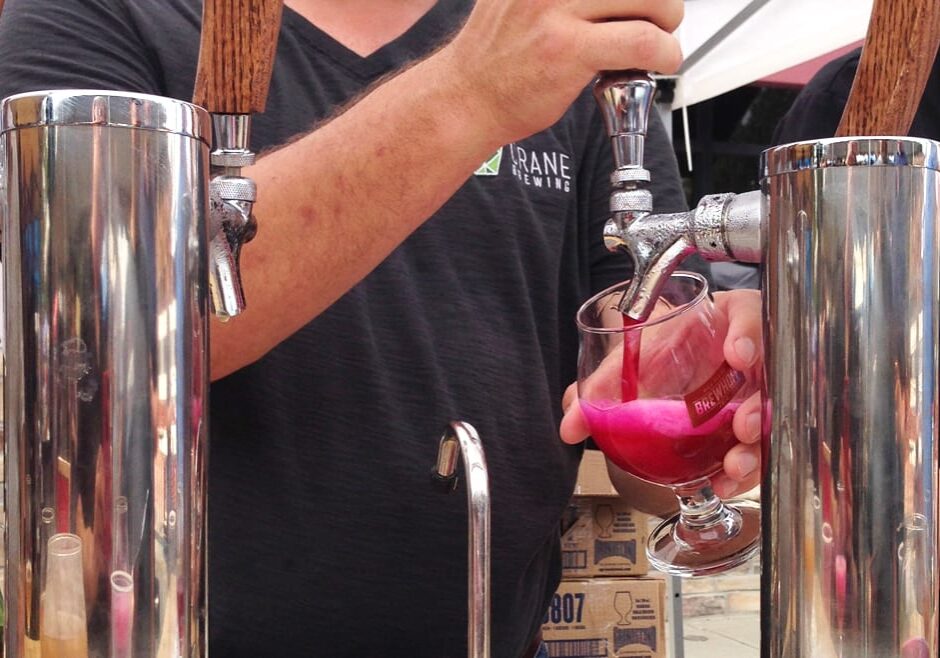 A pink beer being poured.