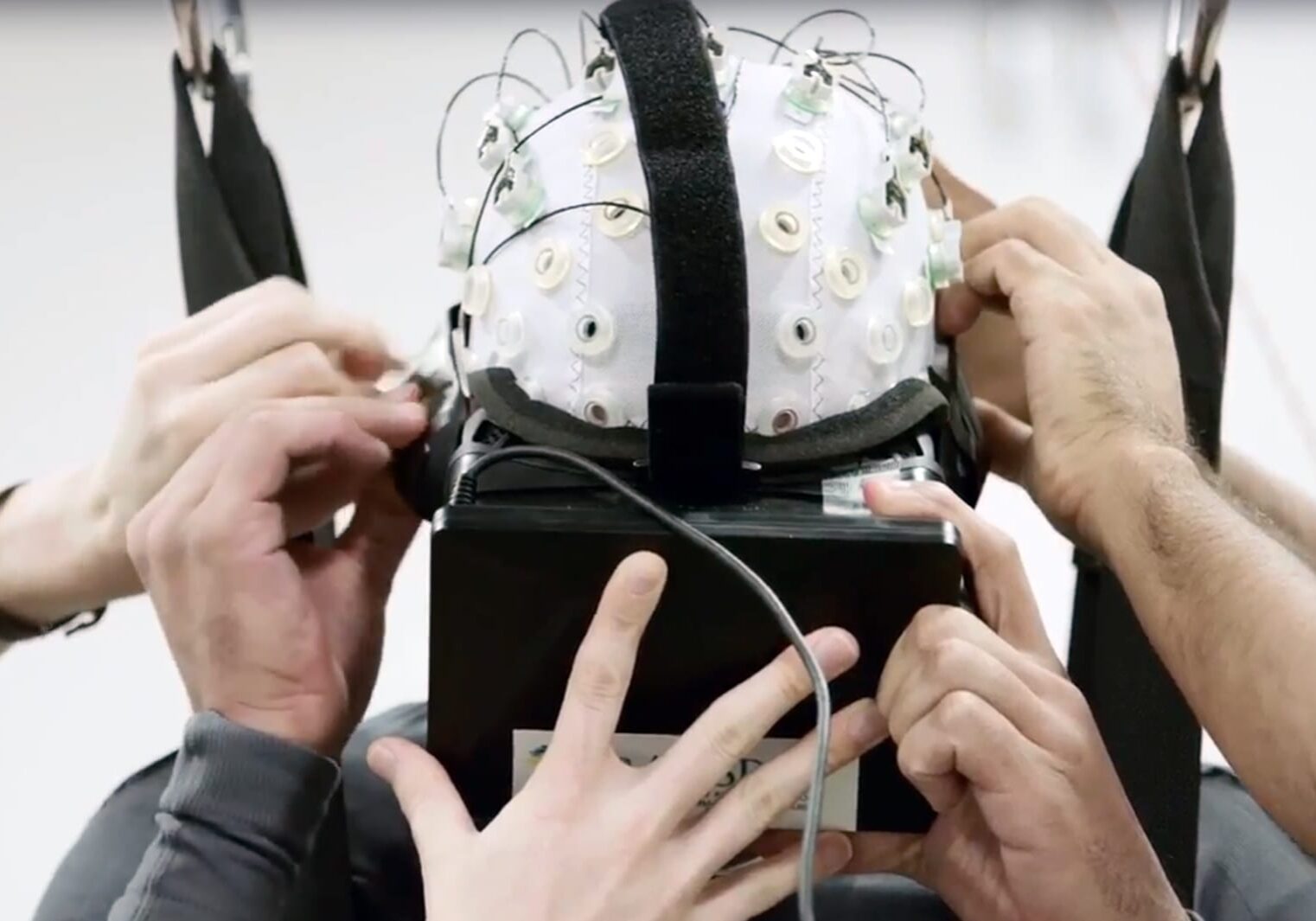 Scientists with the international scientific collaboration known as the "Walk Again Project" use noninvasive brain-machine interfaces in their efforts to reawaken damaged fibers in the spinal cord.