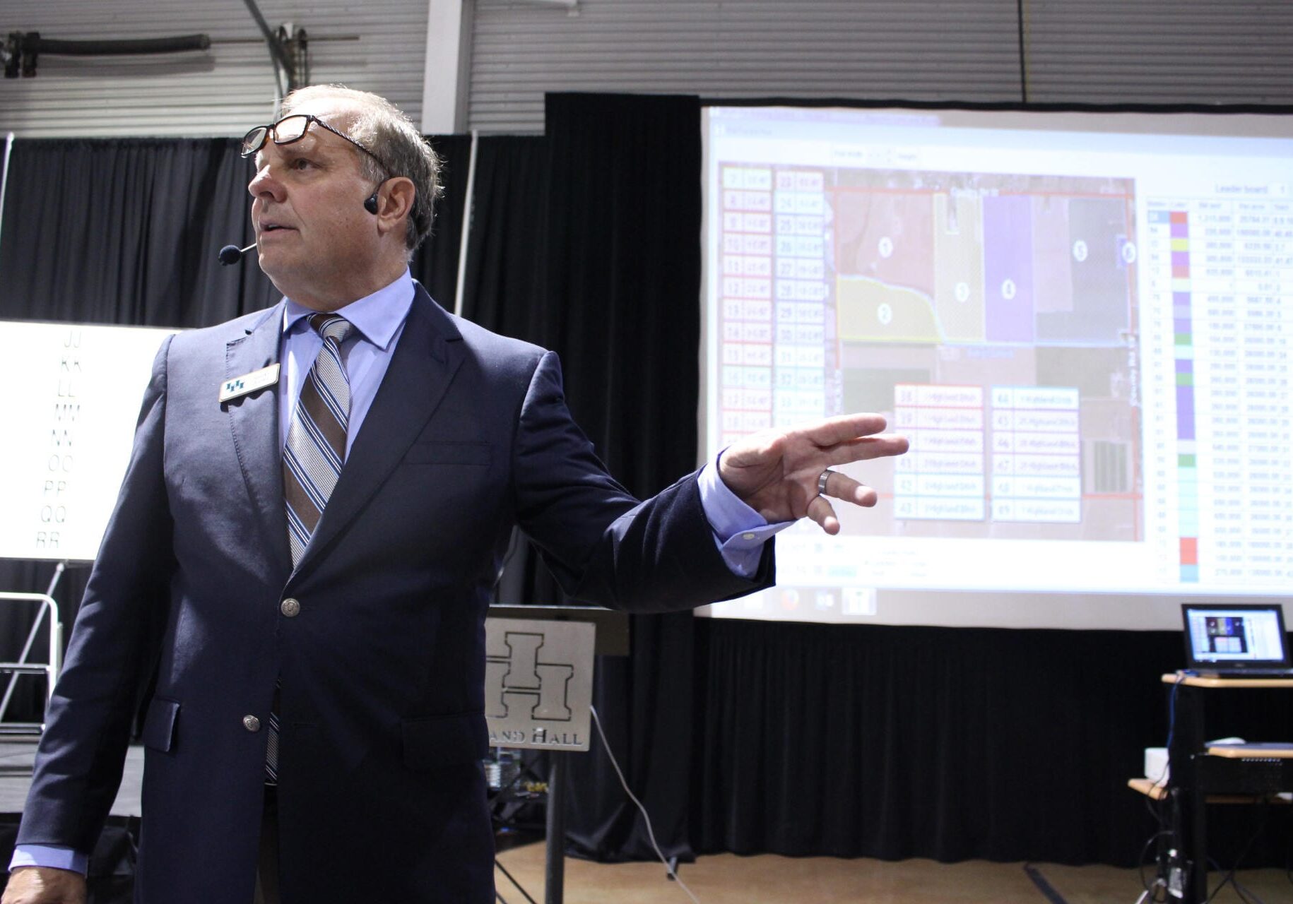 A man stands next to a slideshow.