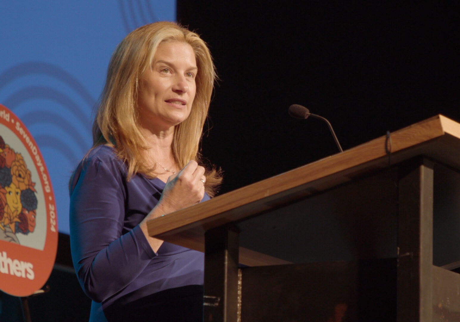 Mindy Corporon speaking at podium.