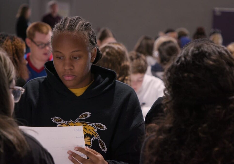 Teen students reviewing papers