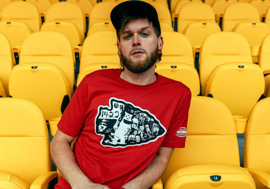 A fan posing in a MADE MOBB Chiefs t-shirt.