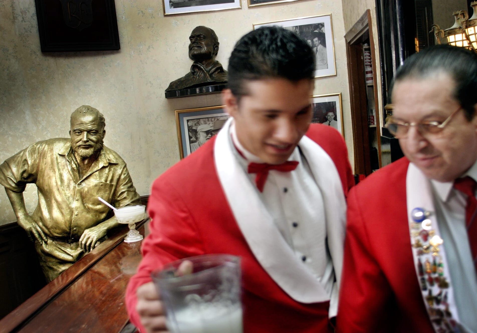 A life-size bronze statue of Ernest Hemingway leans on the bar at the author's regular spot at El Floridita, where every day a daiquiri is set before it.
