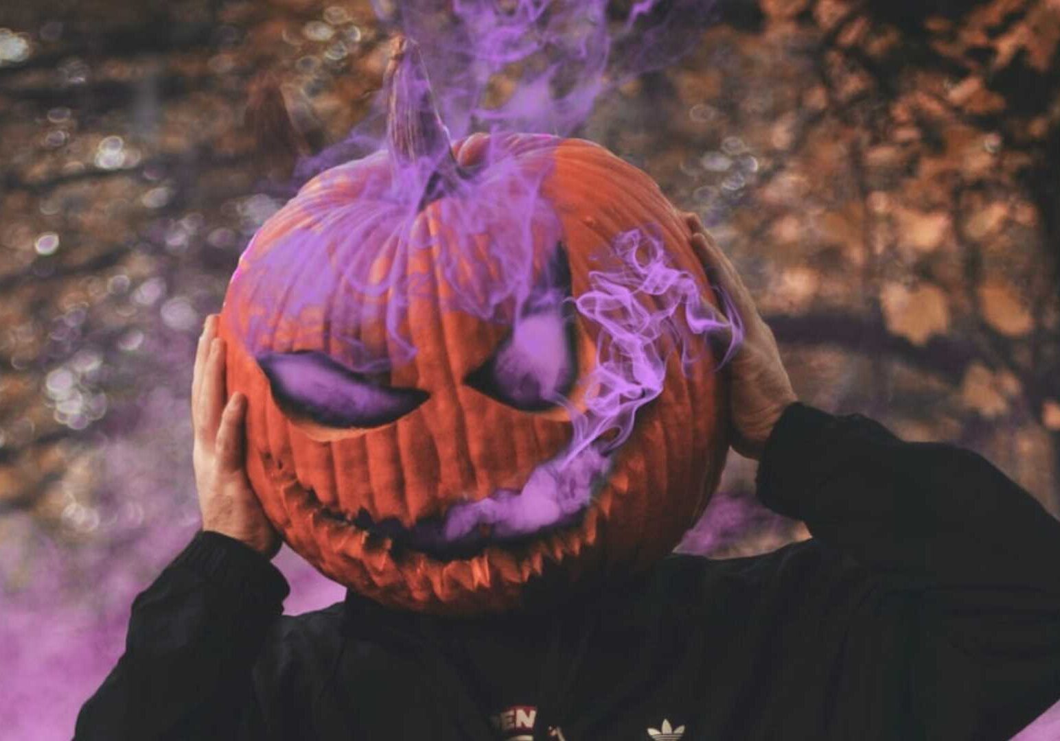 Halloween pumpkin head oozing purple smoke.