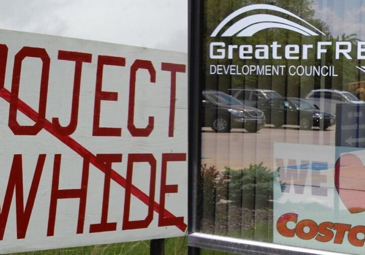 "Project Rawhide" crossed out near a storefront.