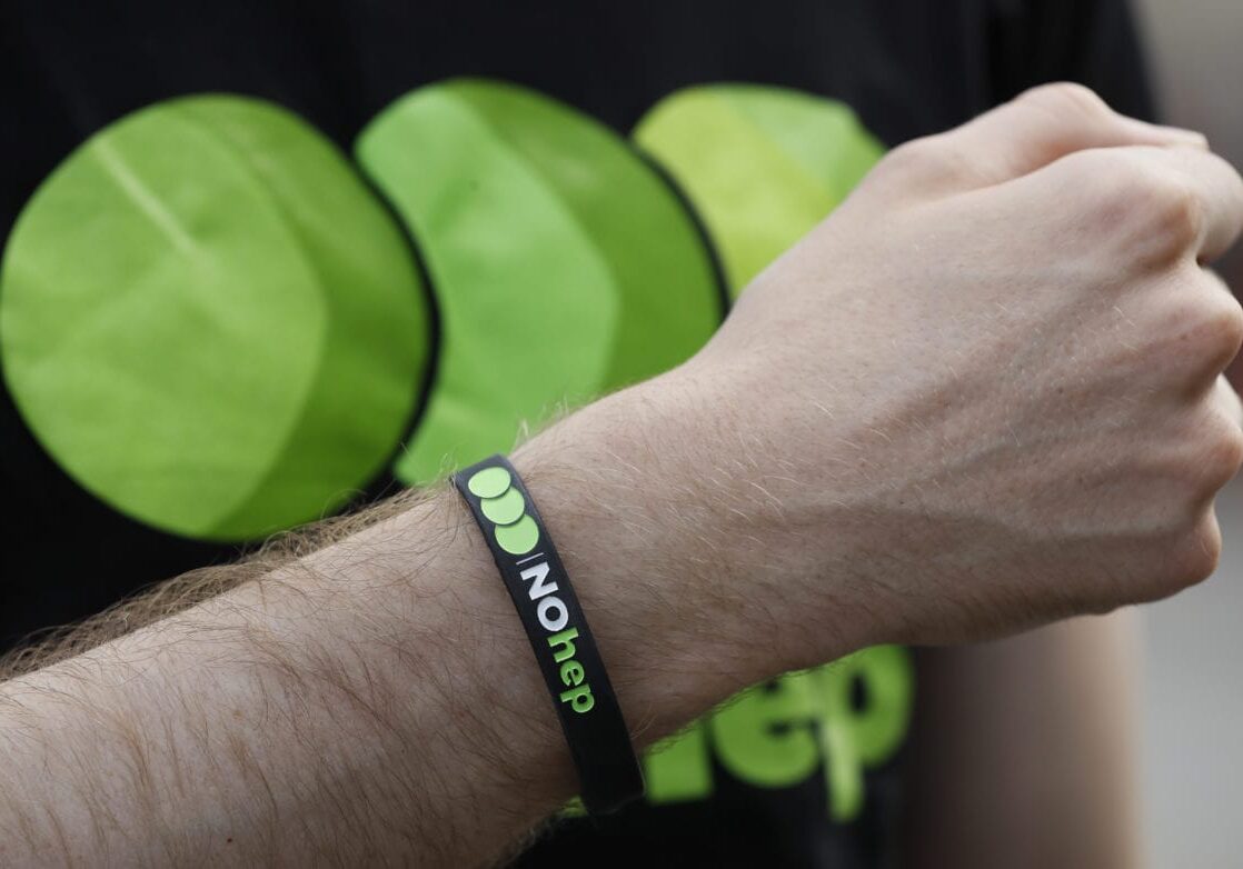 A supporter displays a wristband with the logo displaying 'No hep' during a 'Die-In' to mark World Hepatitis Day at Piccadilly Circus in London, Thursday, July 28, 2016. The event, organised by the Hepatitis C Trust, saw activists, patients and supporters gather to stage a die-in to tell world leaders 'there's no excuse for the 1.4 million hepatitis deaths each year'. (AP Photo/Kirsty Wigglesworth)