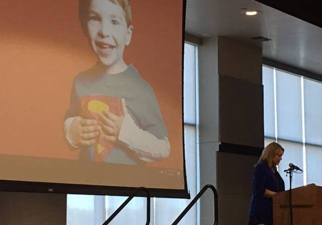 Nicole Hockley (bottom right) addresses the Heartland Coalition Against Gun Violence forum, which took place Monday at the University of Missouri-Kansas City. Her 6-year-old son Dylan, pictured on the screen behind her, was one of the students killed at Sandy Hook Elementary School in December 2012. (Kevin Allen | Take Note)