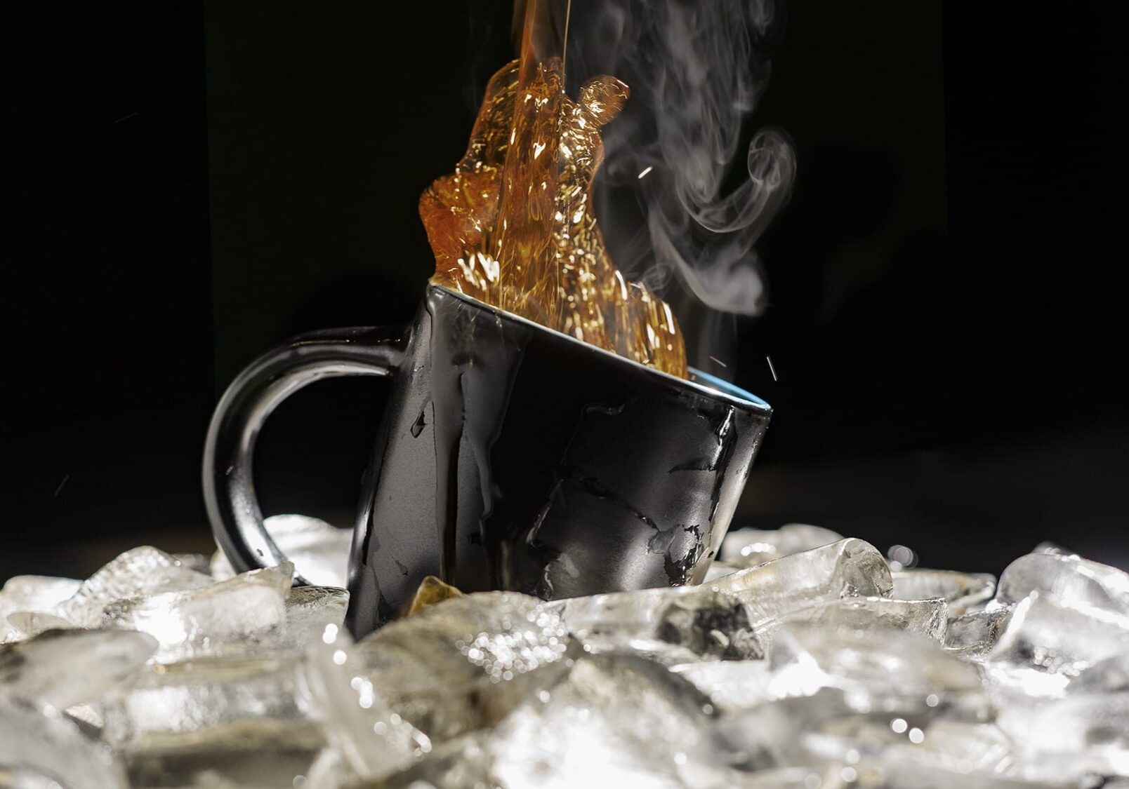coffee pouring into a cup over ice