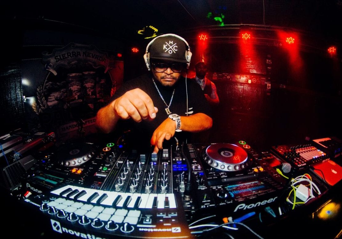 A DJ in front of a keyboard