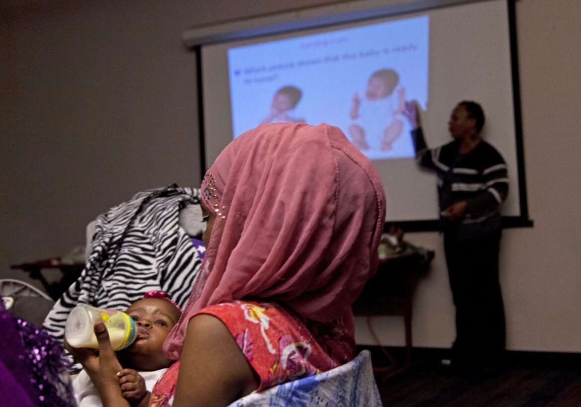 In this Thursday, Dec. 11, 2014 photo, Irena Bottoms feeds her baby as mothers and supportive family members attend a monthly gathering that promotes breast-feeding at a YMCA in Milwaukee. Mothers frequently nurse their babies during the meetings, or feed them bottled breast milk. Breast-feeding is thought to help protect against higher rates of infant mortality and childhood obesity, to more breast cancer deaths and heart disease in adults - and it's much less common among U.S. black women than in whites and others. Rates have improved in recent years but the disparity remains. (AP Photo/Darren Hauck)
