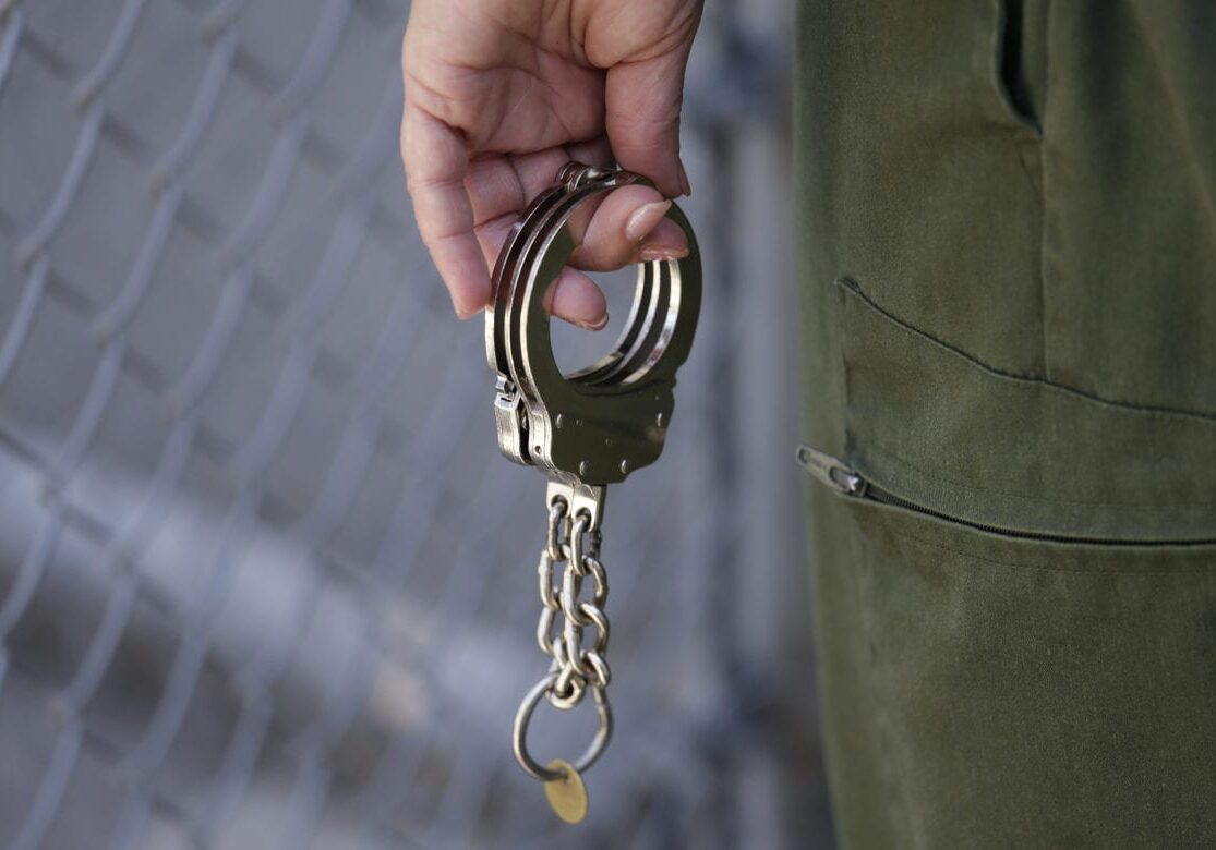 A guard holds a pair of handcuffs to be put on a condemned inmate about to leave an exercise yard death row at San Quentin State Prison Tuesday, Aug. 16, 2016, in San Quentin, Calif.  (AP Photo/Eric Risberg)