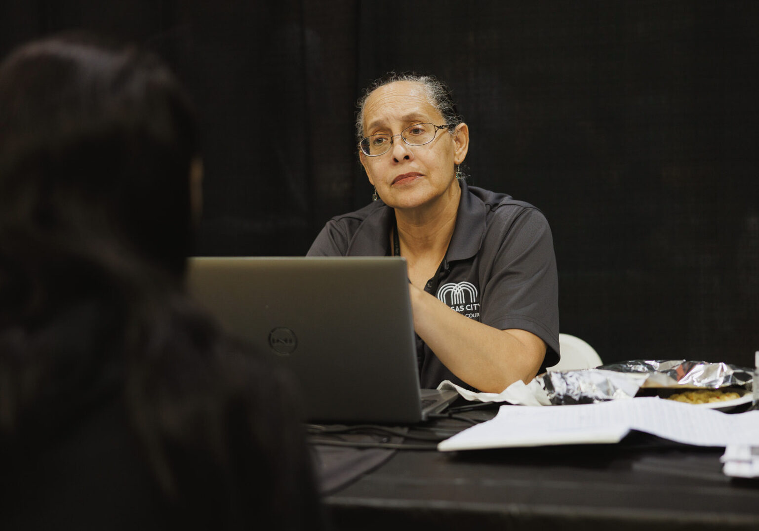 Kansas City Municipal Judge Martina Peterson listens to an attendee at a May 13, 2025, ReStart/Project Homeless Connect event at the Gregg/Klice Community Center. Peterson was representing Kansas City's new Community Court. (Chase Castor | Flatland)