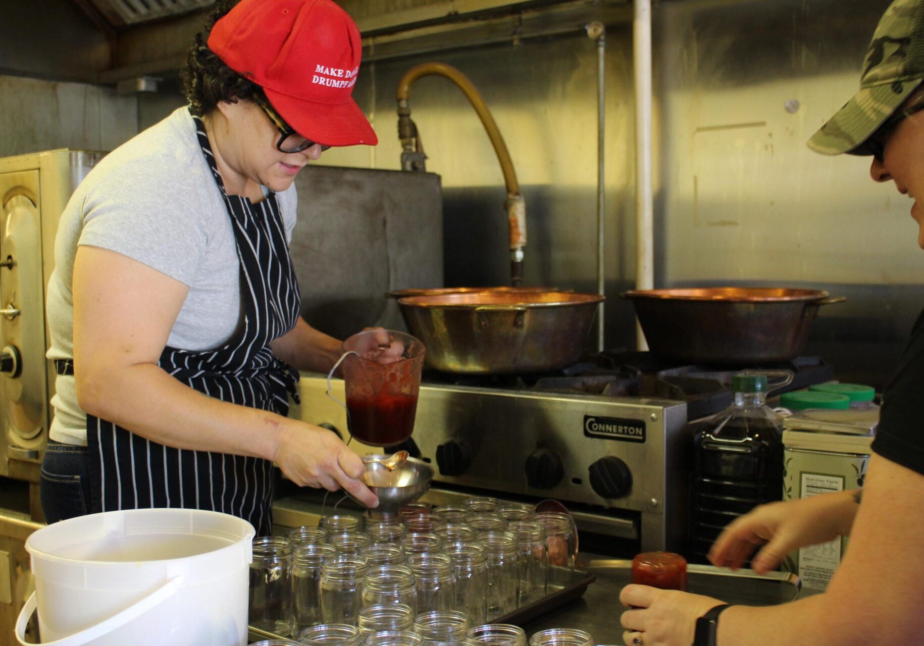 A woman filling jars.