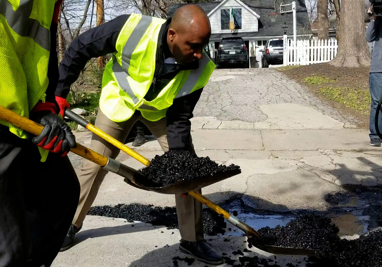 Quinton Lucas shovels asphalt