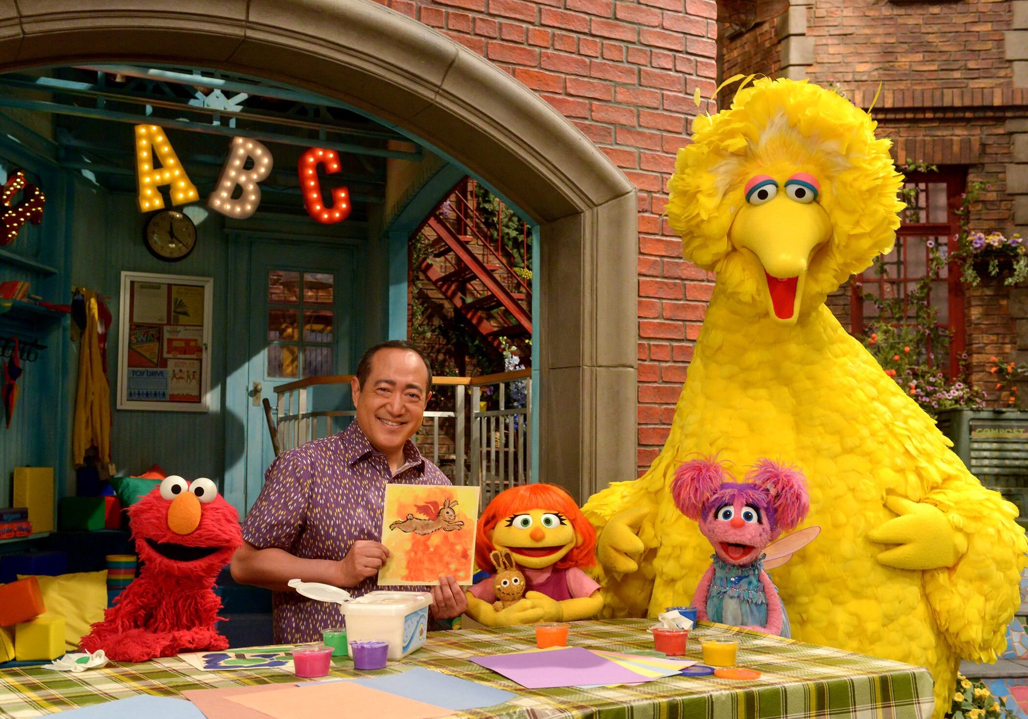 Julia (center) first appeared online and in printed materials as a part of <em>Sesame Street</em>'s<a href="http://autism.sesamestreet.org/storybook-we-are-amazing/" target="_blank"> See Amazing in all Children</a> initiative. She'll now appear on TV as well. From left, Elmo, Alan Muraoka, Julia, Abby Cadabby and Big Bird.