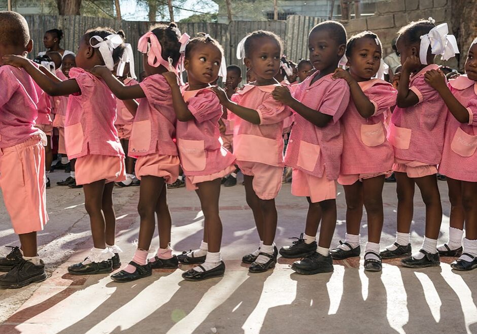 Image from "A Path Appears" of little girls standing in a line.