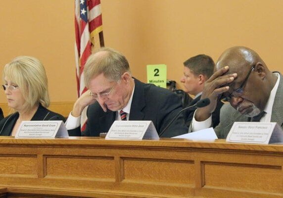 panelists looking down during hearing. photo credit Jim McClean