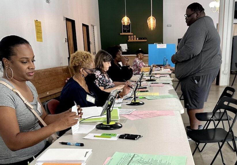 Poll workers check in a voter during Georgia’s May primary at a Marietta polling place.