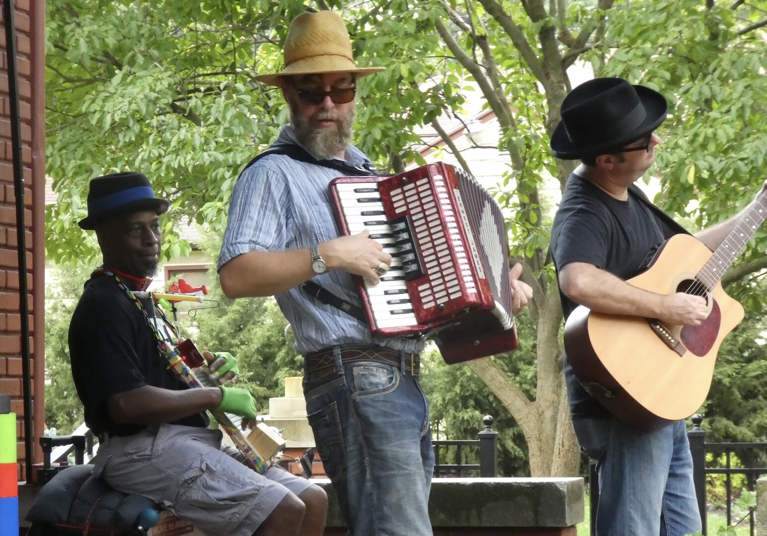A man plays an accordion with his band.