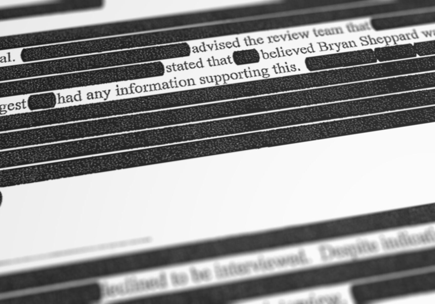a portion of a heavily redacted report