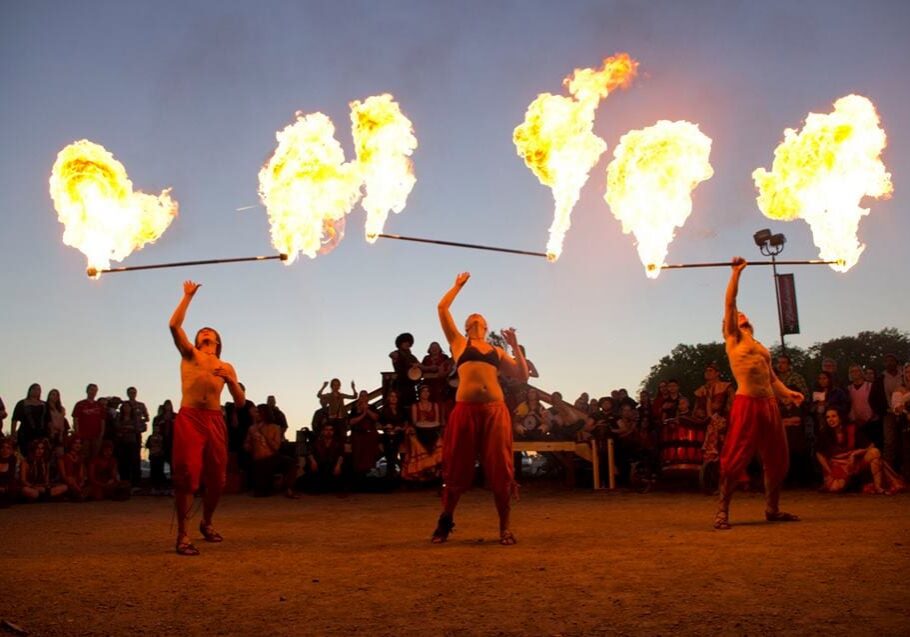 Fire twirlers perform.