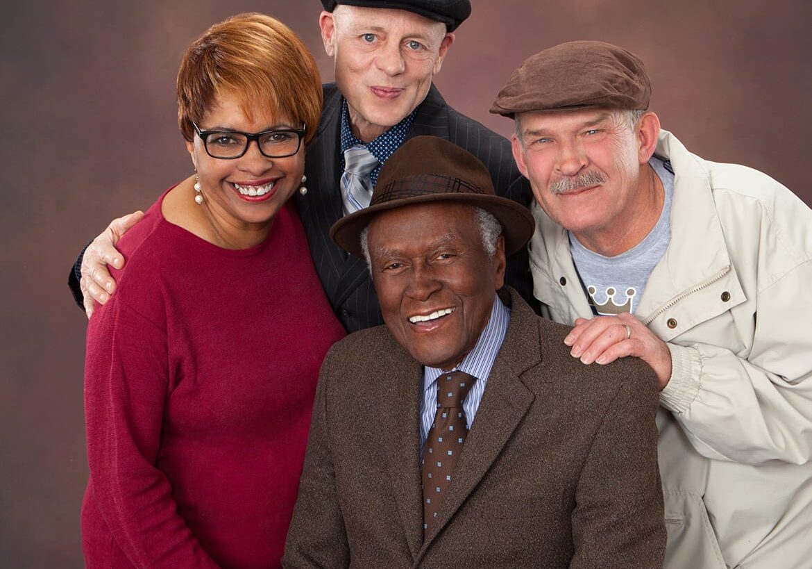 three former students surround Alvin Brooks in a portrait