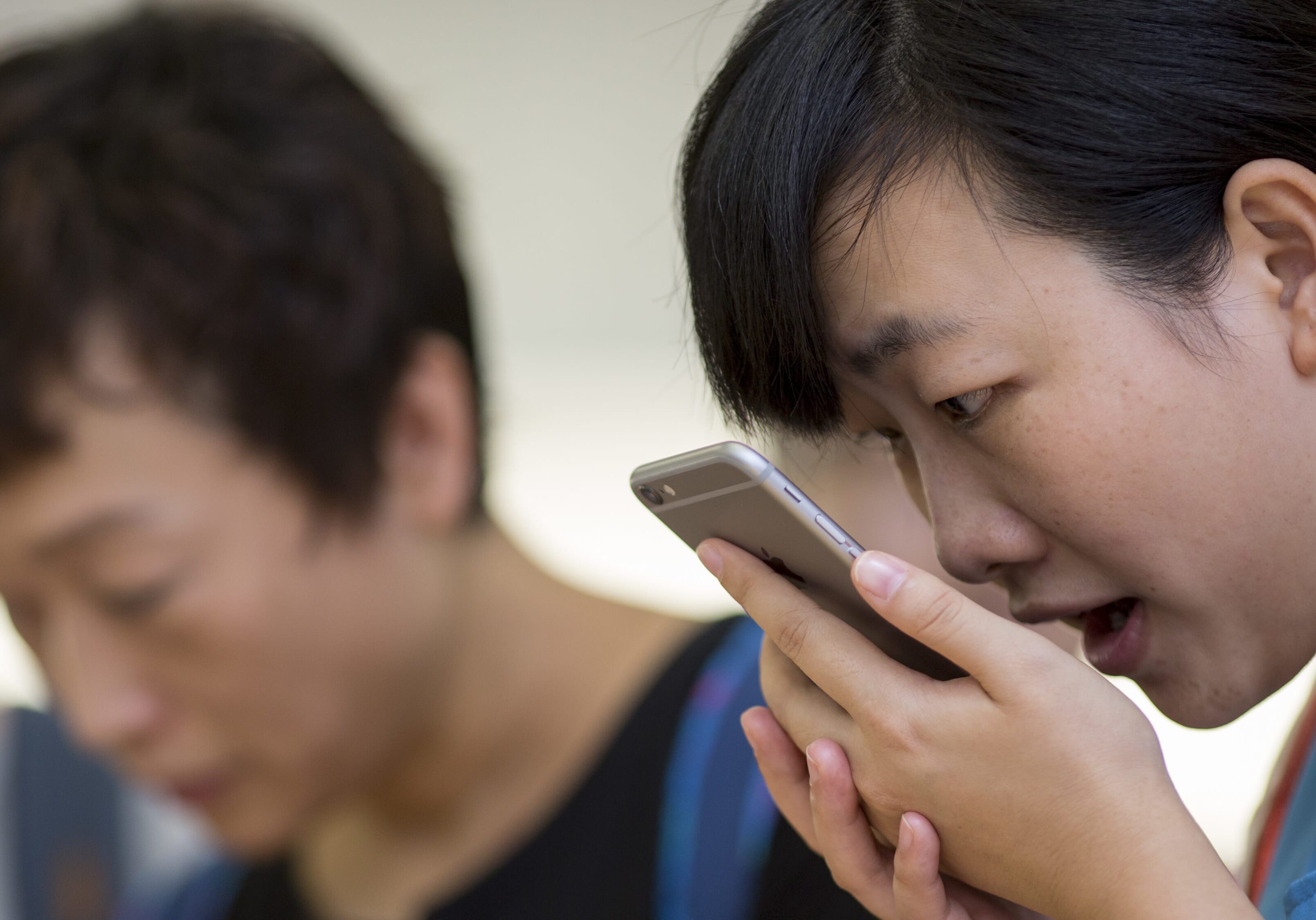 A customer tries the Siri voice recognition function on an Apple iPhone 6 Plus in Hong Kong.