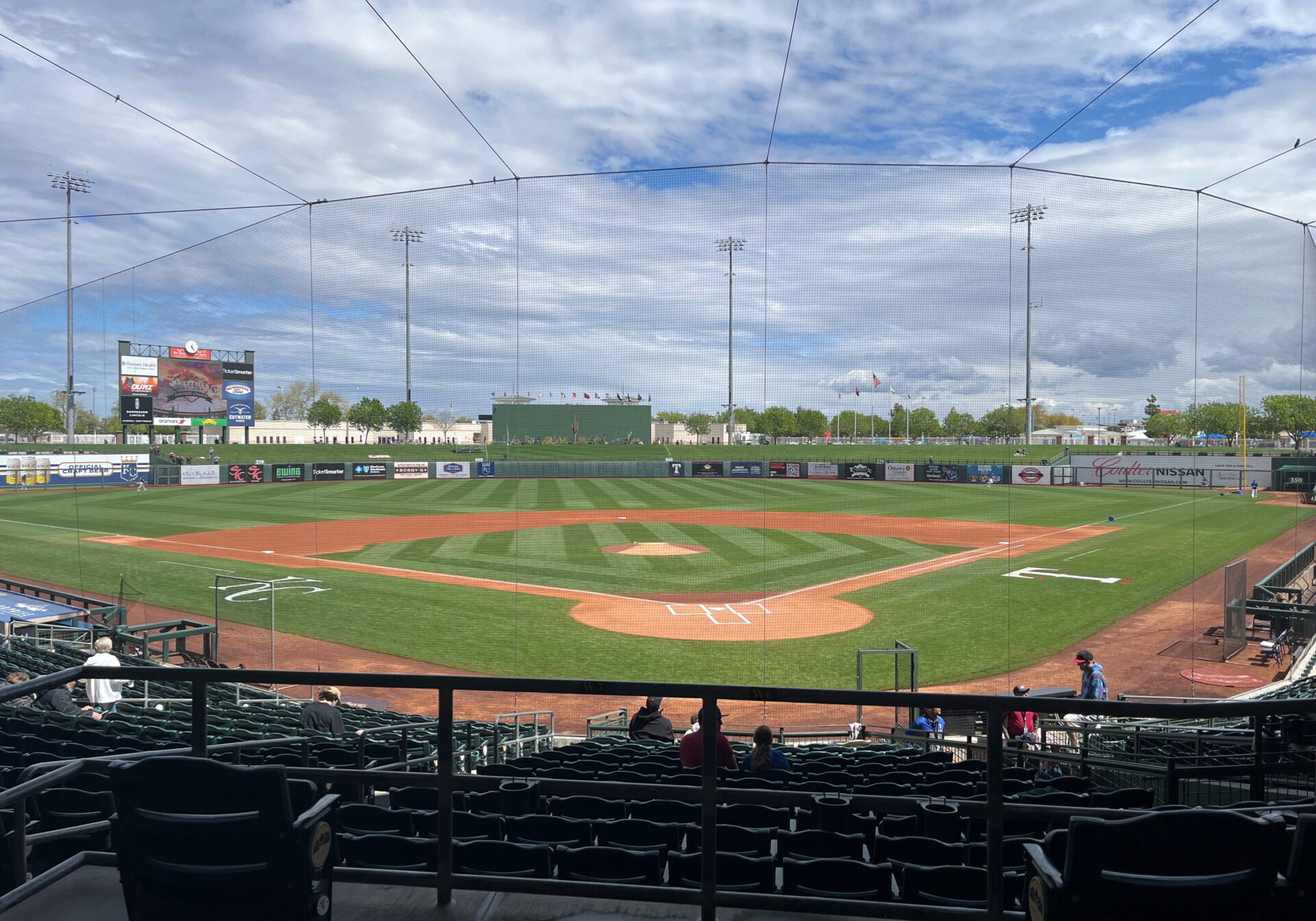 This photo was taken at Surprise Stadium before a game in March 2023. Almost no one is on the field, but it is entirely visible, with a netting in the way.