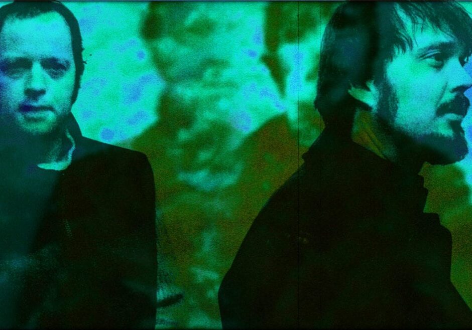 An artistic, blue-toned image of two men